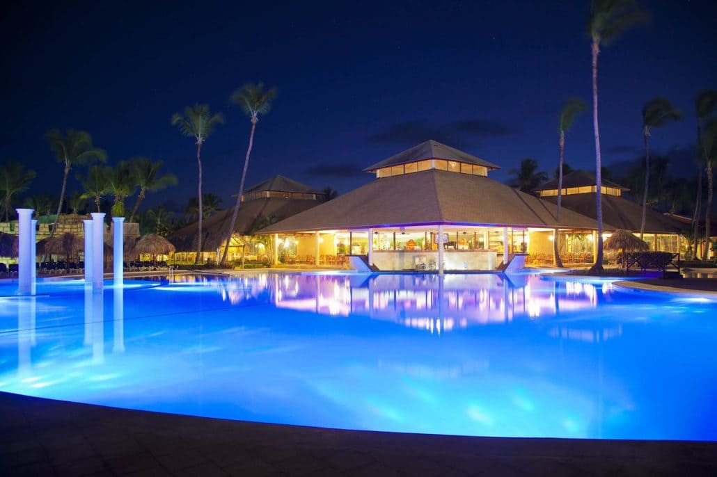 Resort pool and restaurant illuminated at night