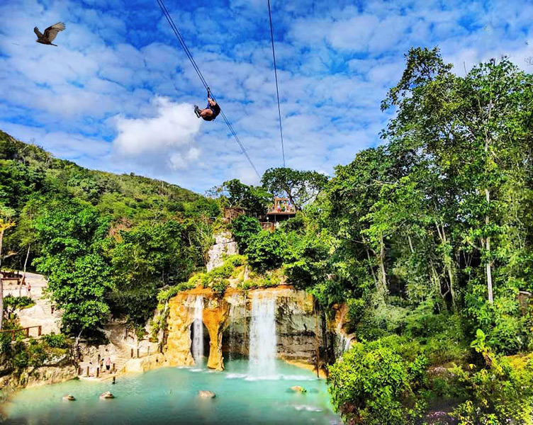 Zip line over waterfall in Scape Park